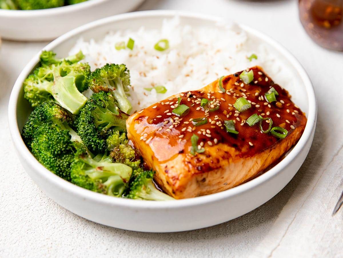 A bowl with air fryer teriyaki salmon served with broccoli and rice.