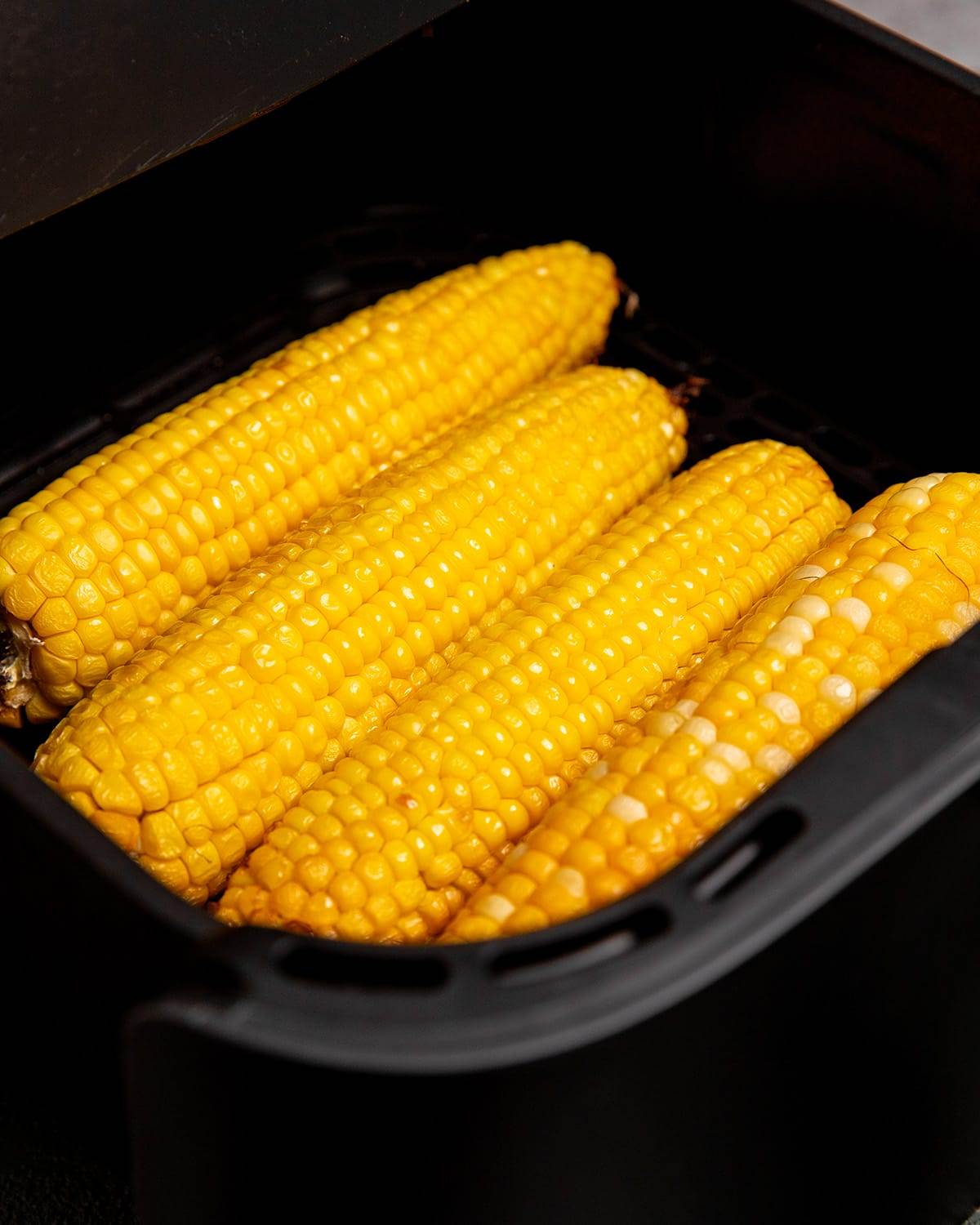 Roasting corn on the cob in an air fryer to make street corn recipe.