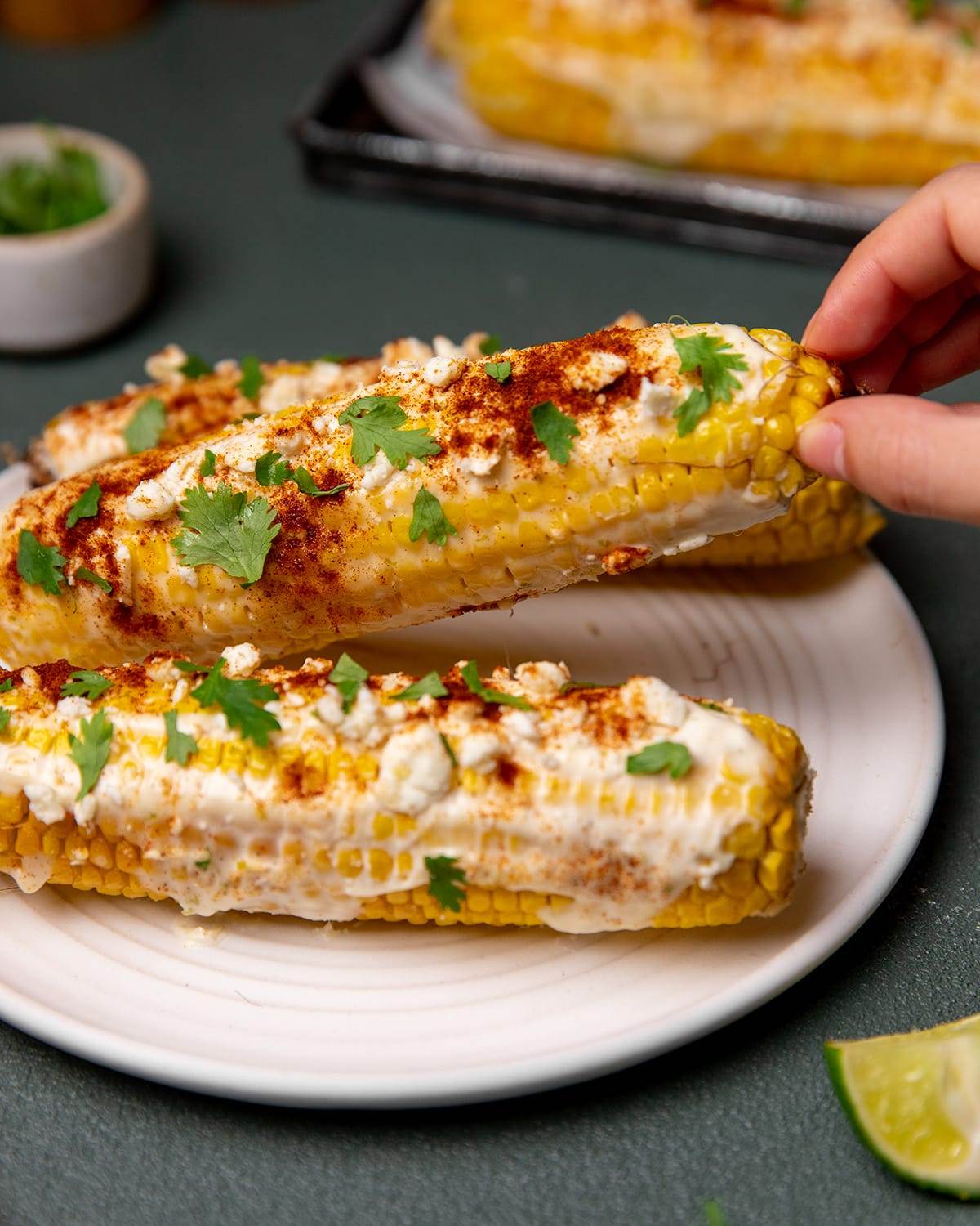 Adding all the toppings to Mexican Street Corn made in an air fryer!
