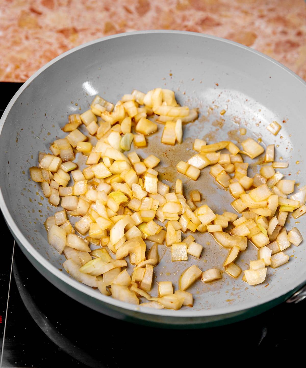 Sautéing onions for pork tacos recipe.