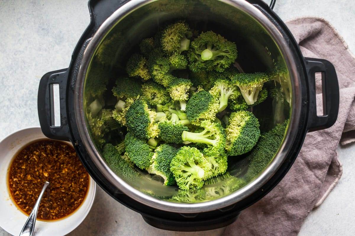Cooking broccoli in an Instant Pot for a beef and broccoli recipe.