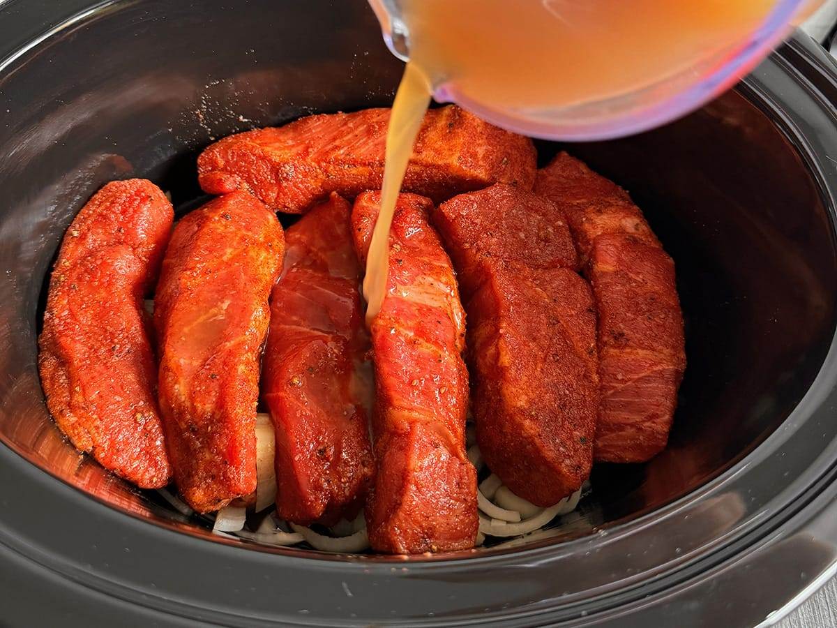 Country-style ribs cooking in a slow cooker.