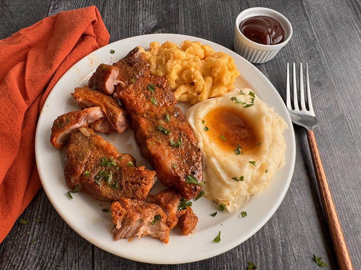 Slow cooked country-style ribs served with mashed potatoes and mac and cheese.