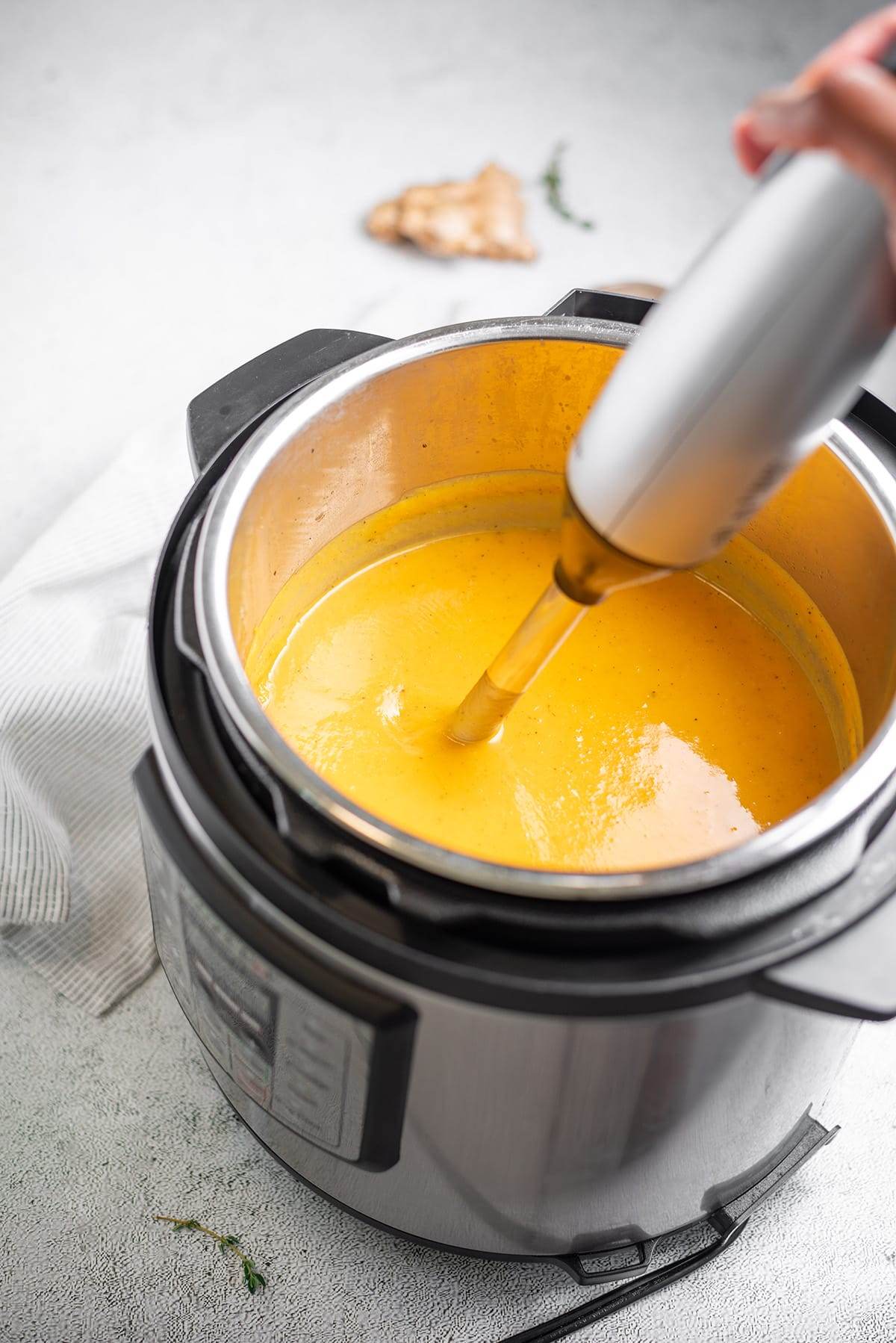 Using an immersion blender for making Instant Pot butternut squash and sweet potato soup.