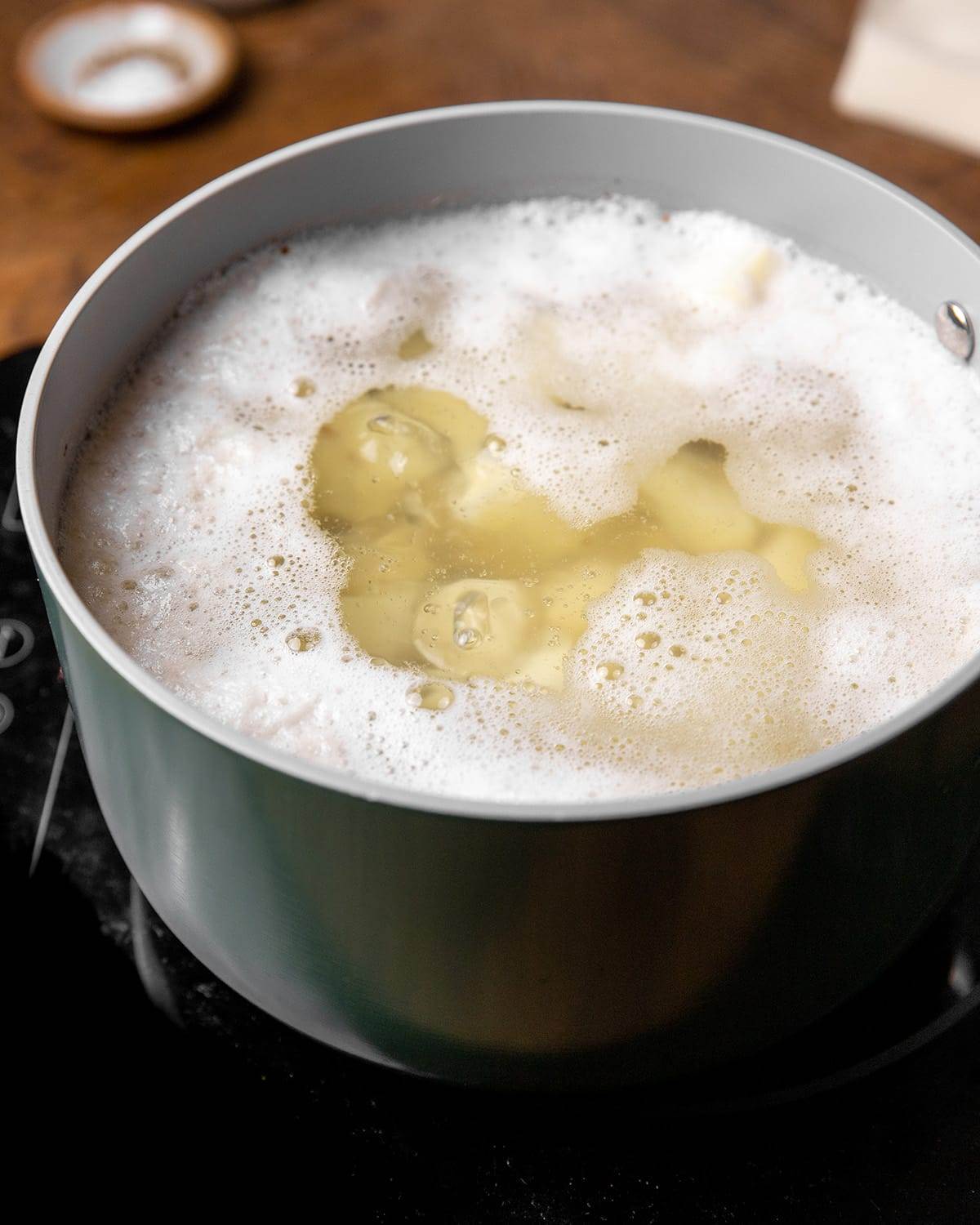 Potatoes boiling in water to be made into mashed potatoes.