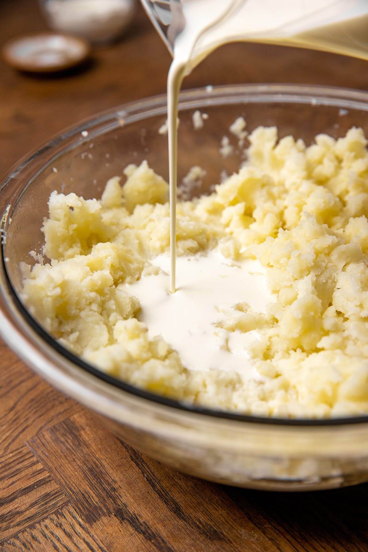 Pouring cream into mashed potatoes