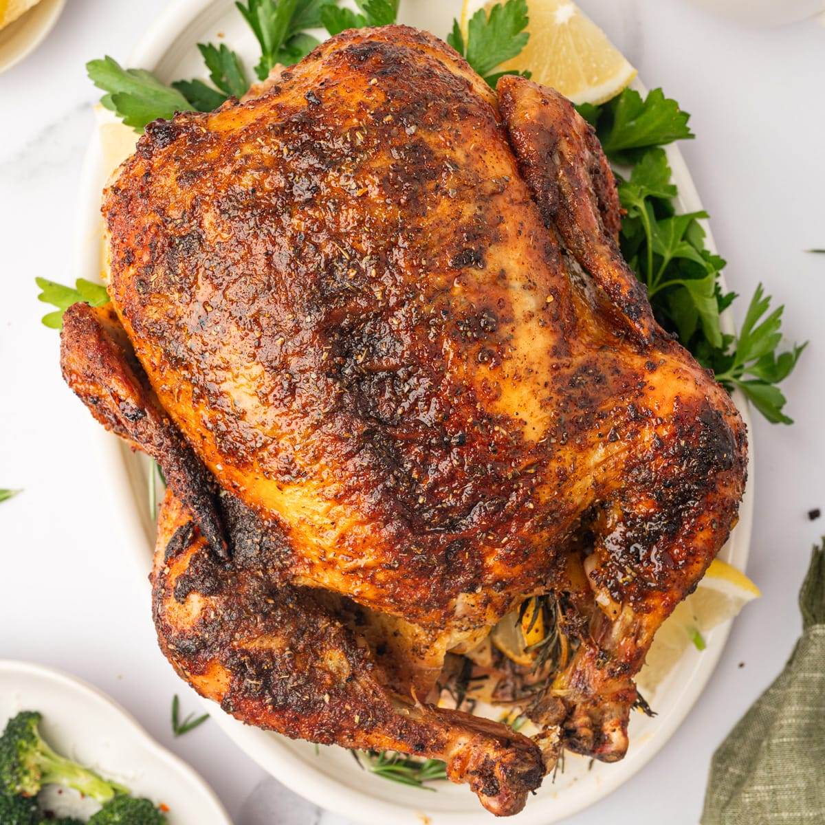 Whole roasted chicken on a plate.