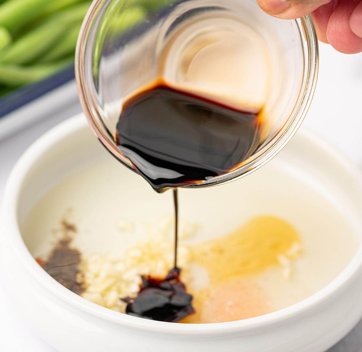 Mixing the honey and balsamic for our baked green beans with cranberries and almonds.