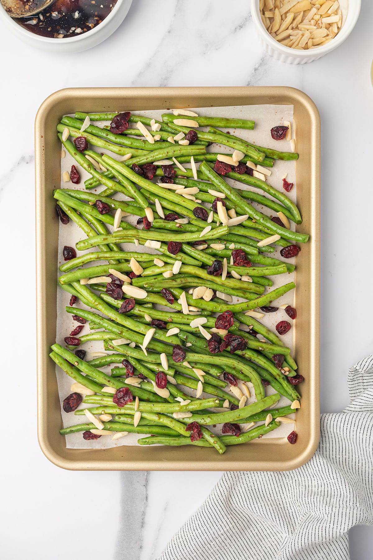 Take your green beans to the next level with this simple baked recipe. Sweet cranberries, nutty almonds, and a rich honey balsamic glaze make it unforgettable!