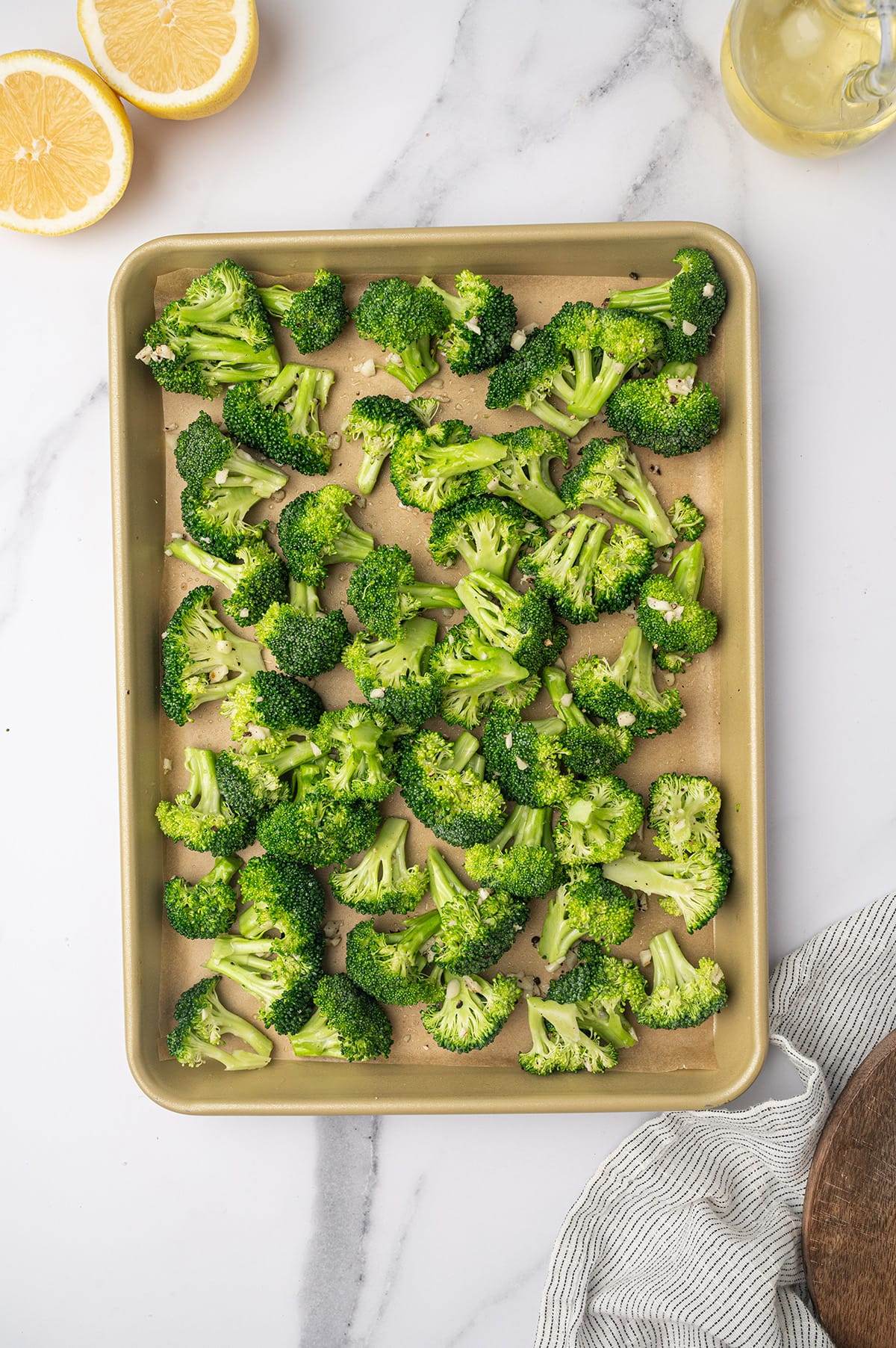 Broccoli florets on a sheet pan ready to go into the oven.