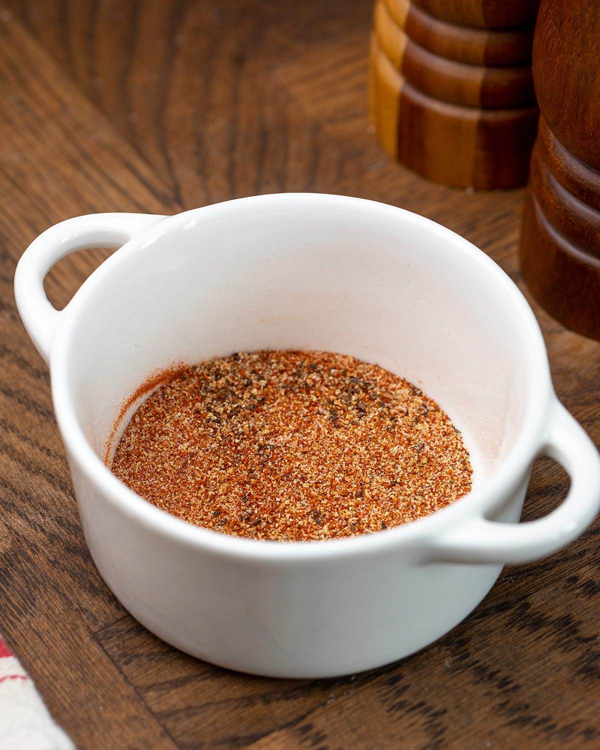 A bowl with the seasonings to make oven roasted BBQ chicken thighs.