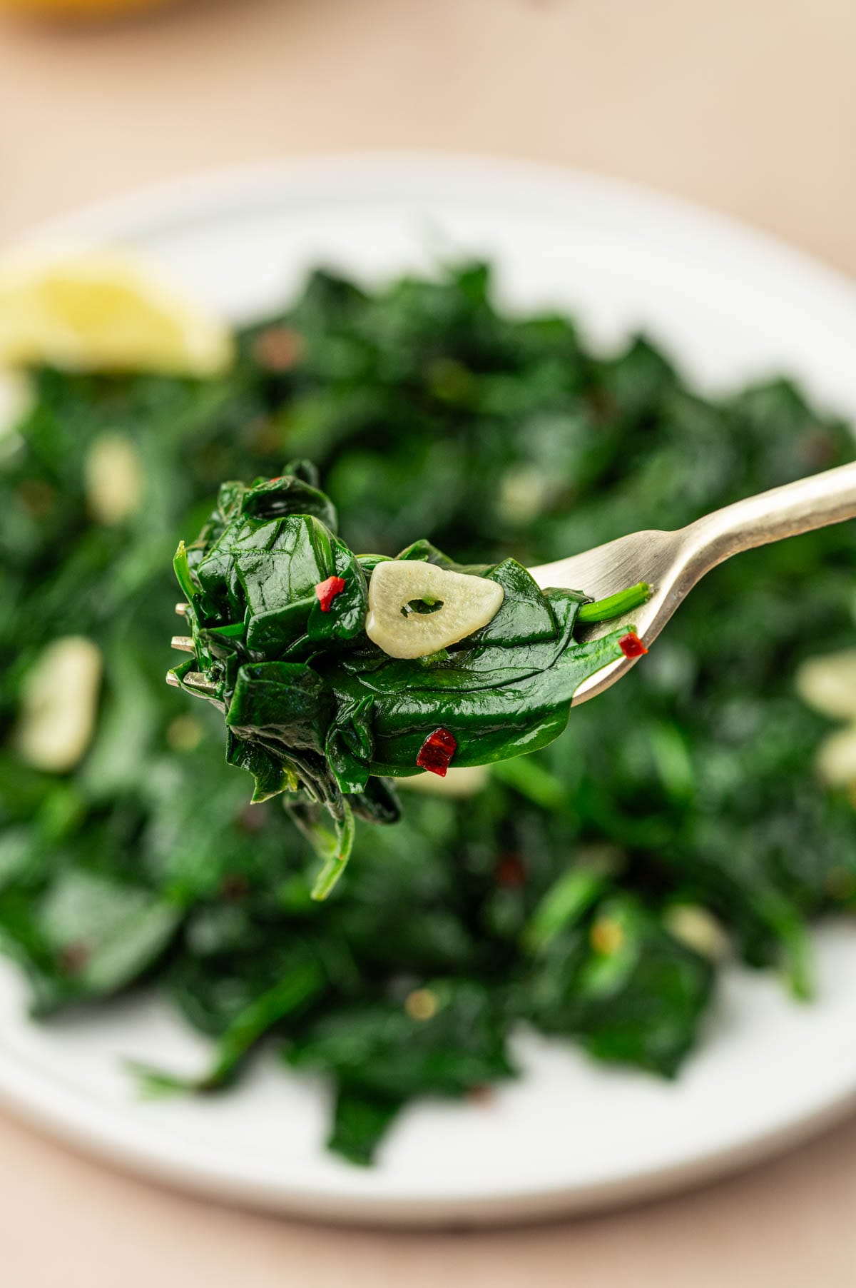 A fork full of our easy sautéed spinach.