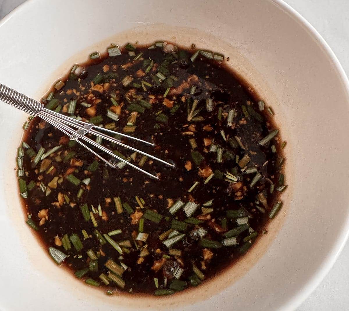 Mixing the glaze ingredients to make easy stovetop balsamic pork tenderloin.