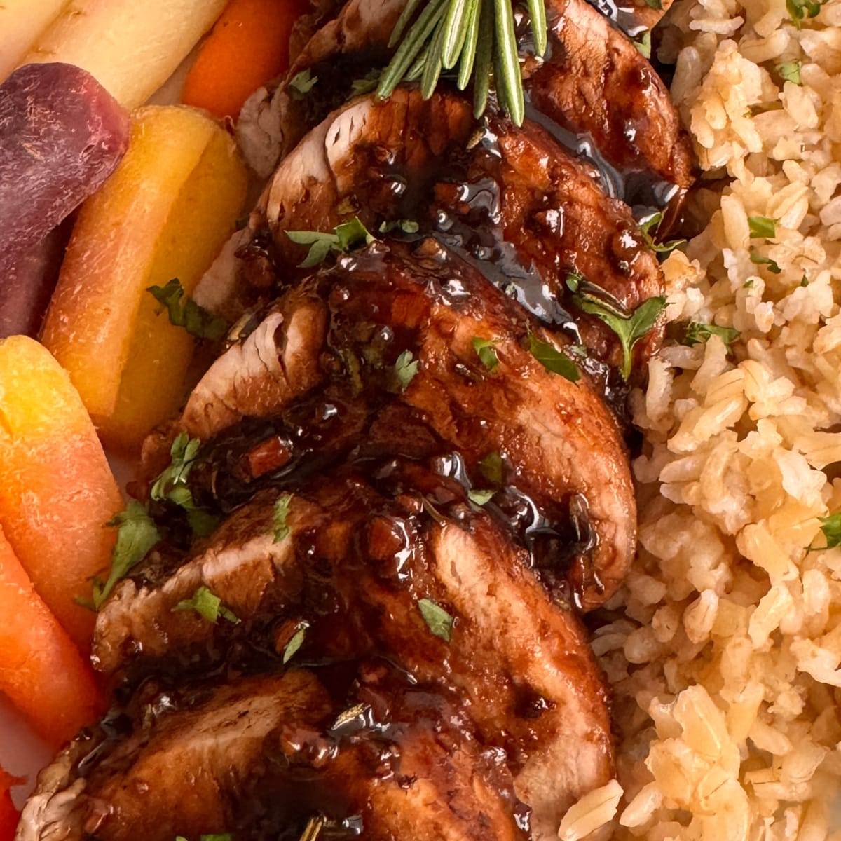 Stovetop balsamic pork tenderloin served with carrots and brown rice.