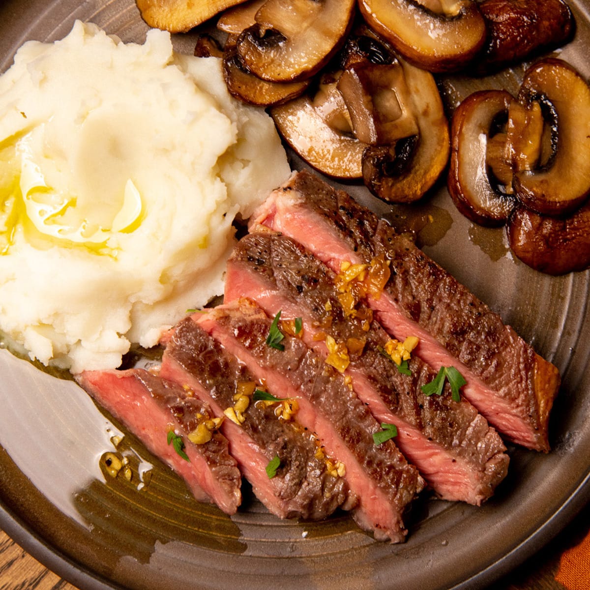 A steak made via sous vide, served with mushrooms and potatoes.
