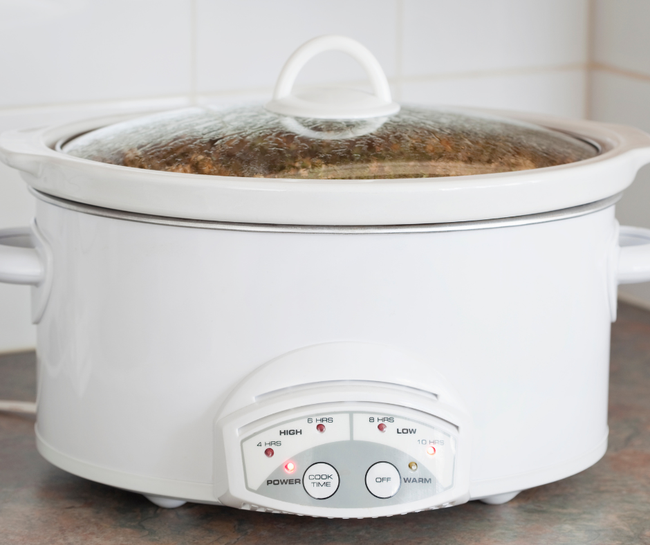A white slow cooker cooking up a tasty meal.