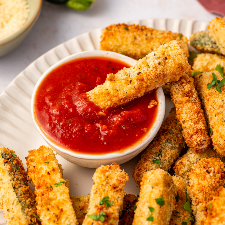 Air fryer zucchini fries with a side of marinara sauce.