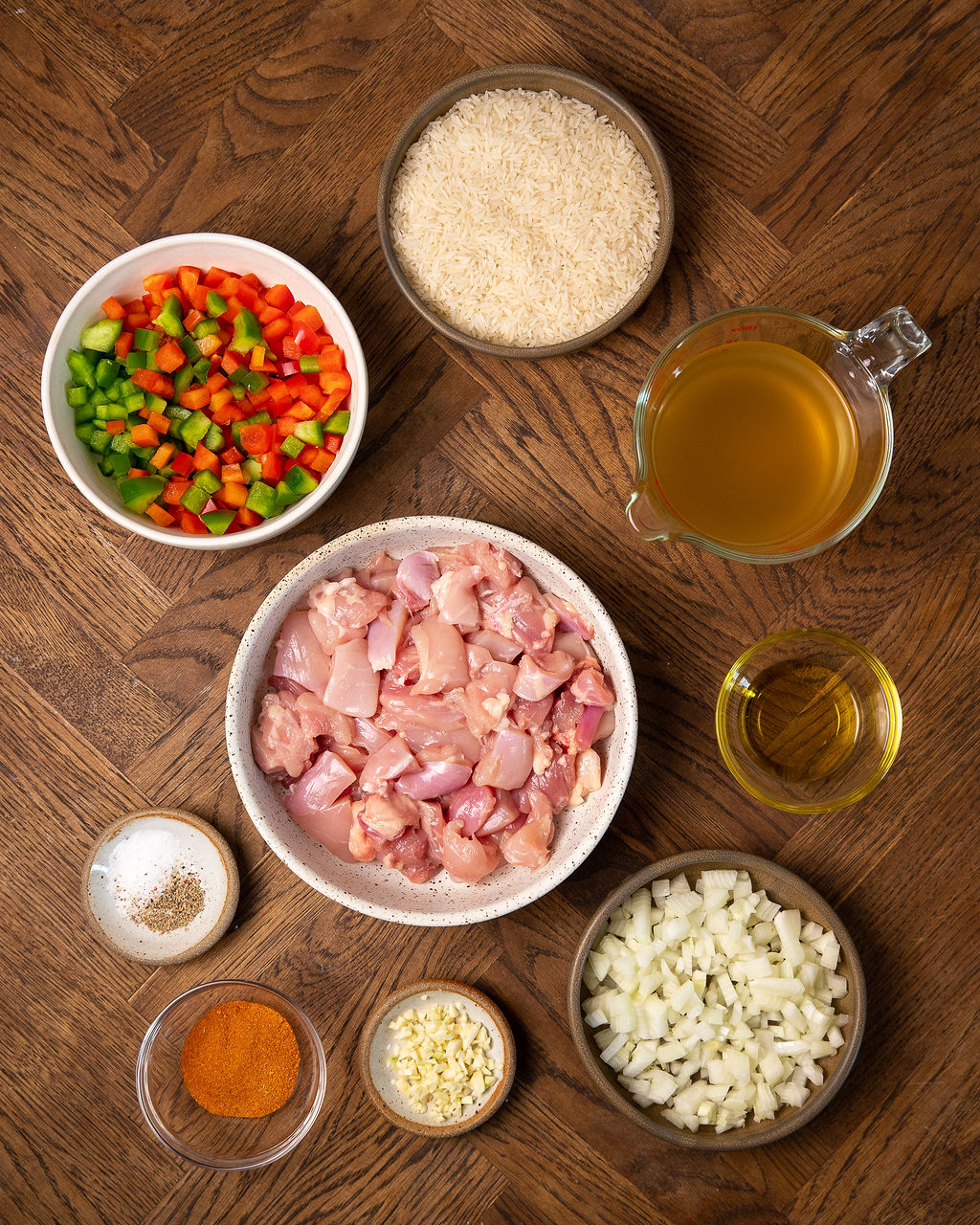 Ingredients for Instant Pot Cajun chicken and rice on a wooden table.
