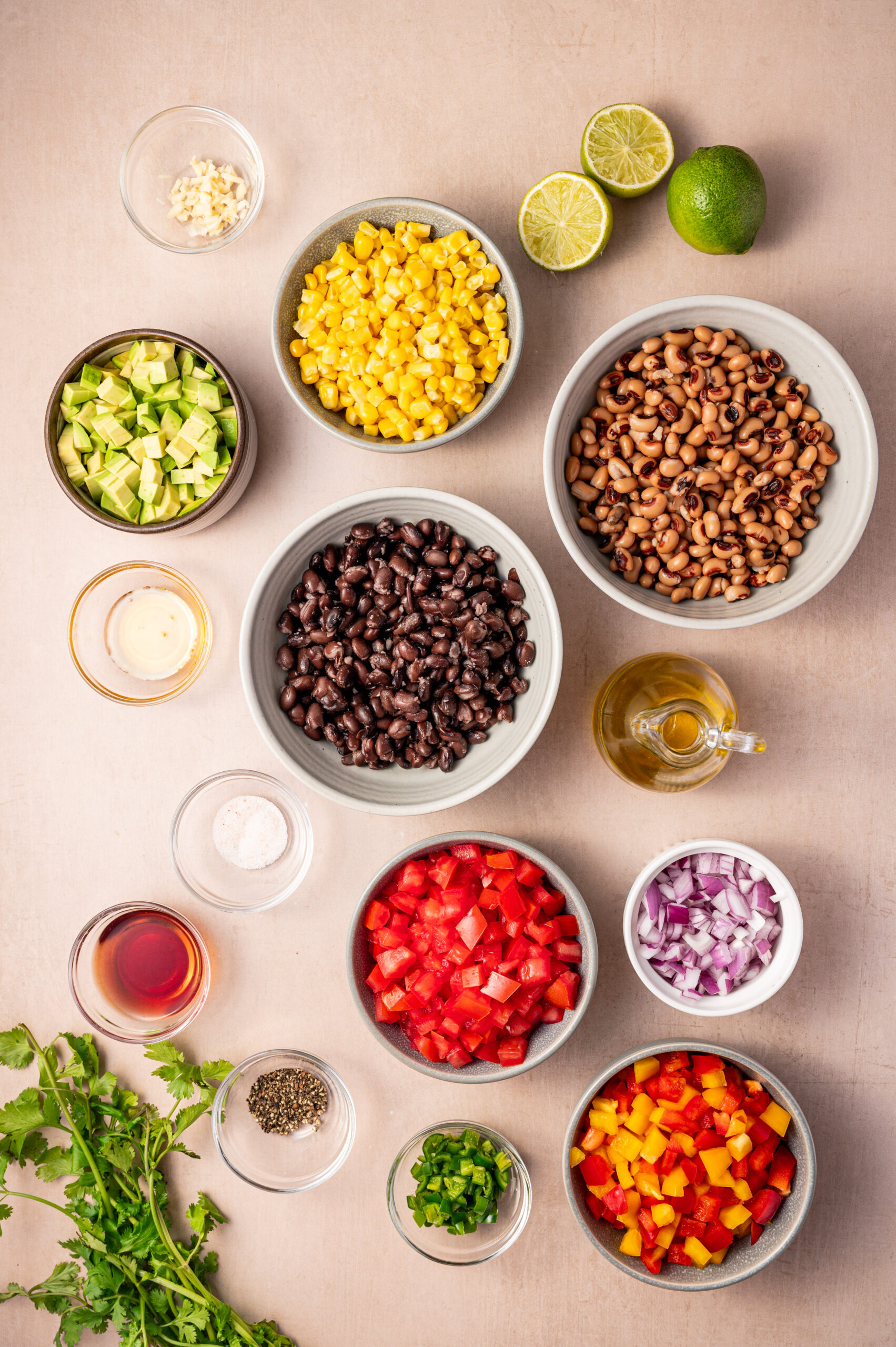 Cowboy caviar ingredients spread out on a kitchen counter.