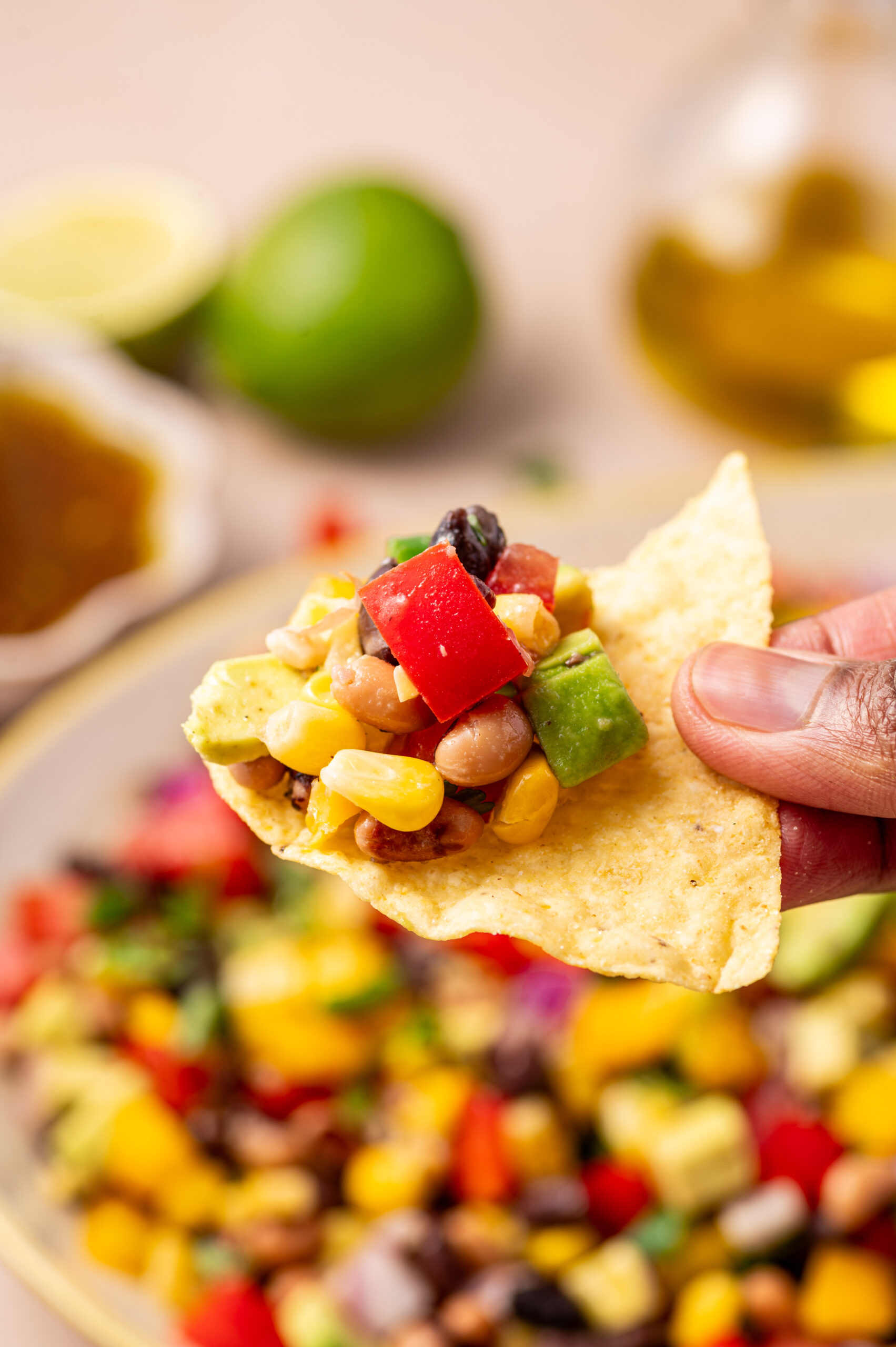 A scoop of cowboy caviar on a tortilla chip.