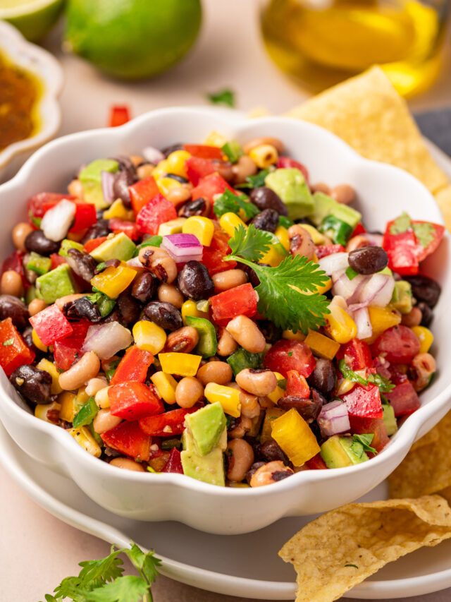 Colorful cowboy caviar in a white serving bowl.