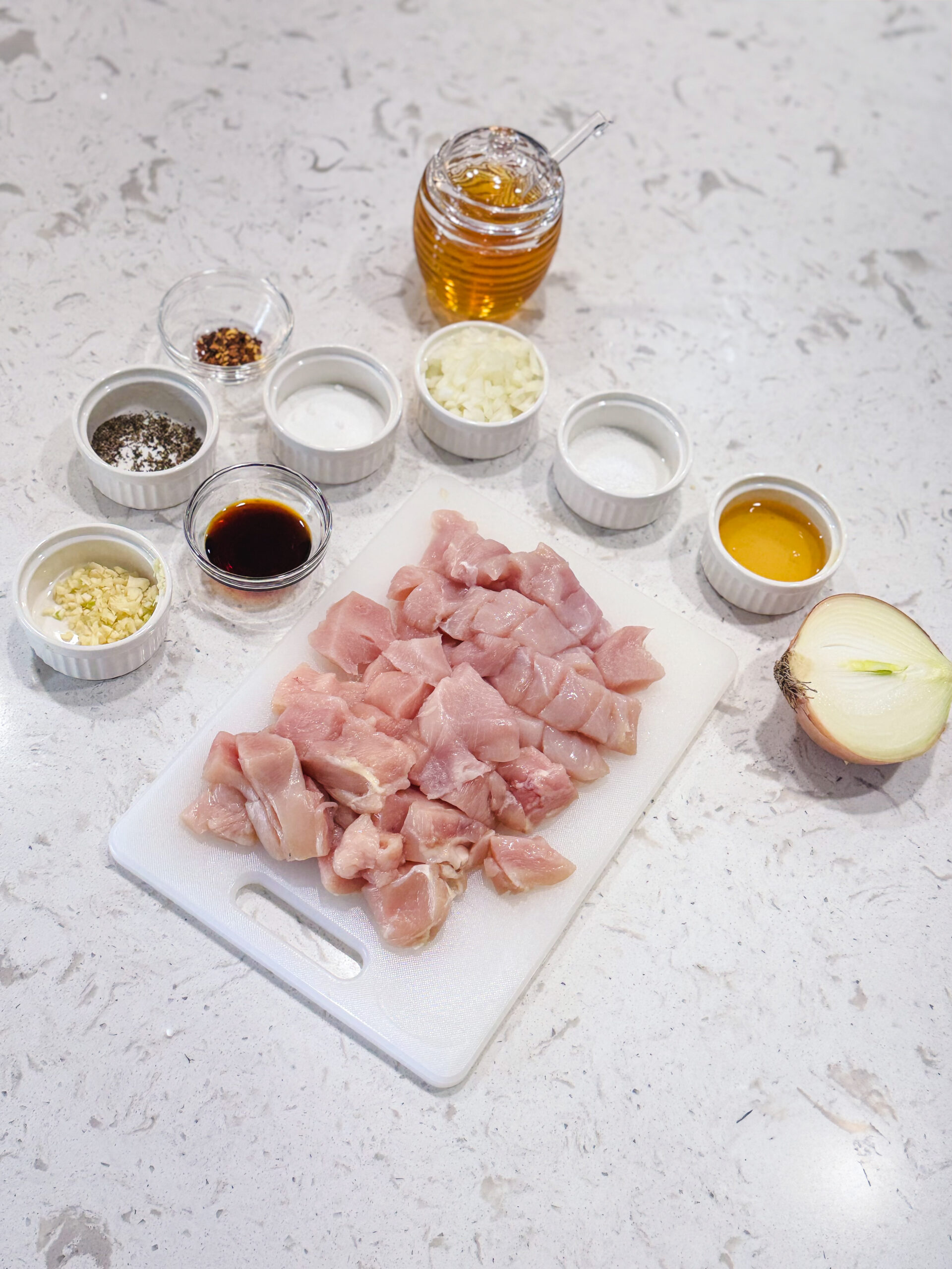 Ingredients for honey garlic chicken on a white counter top.