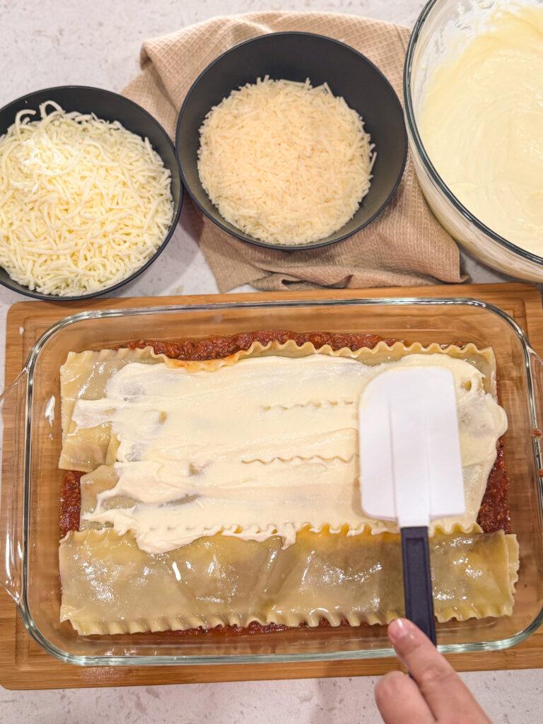 Layering on the ricotta cheese mixture for oven baked lasagna.