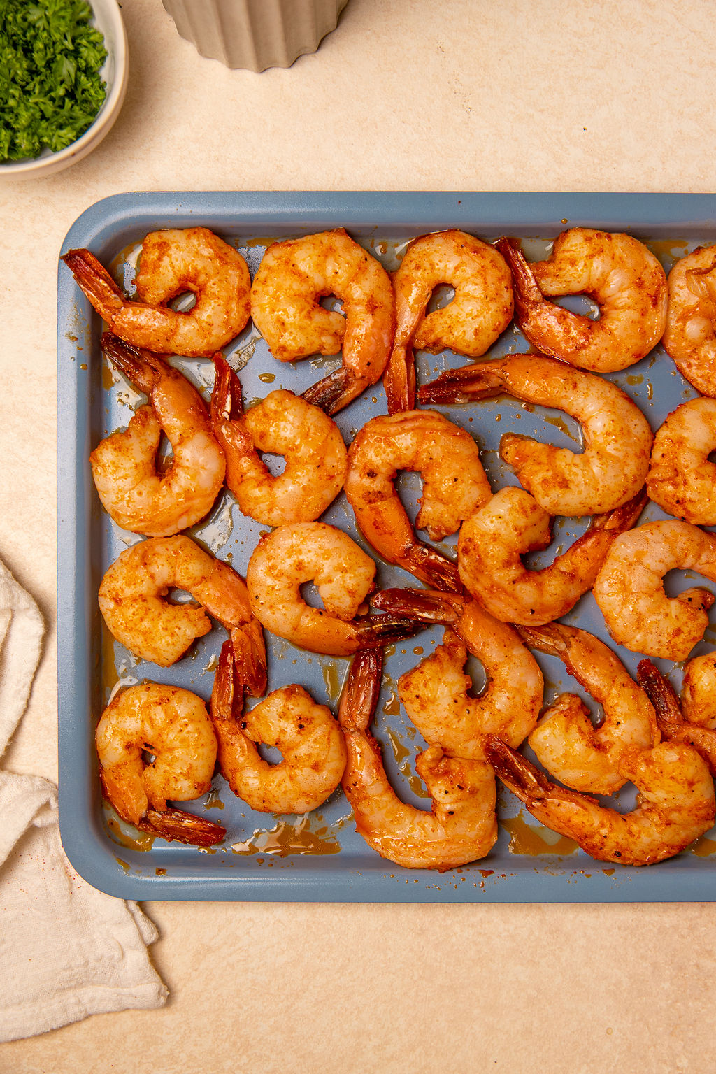 Roasted shrimp on a baking sheet fresh out of the oven.