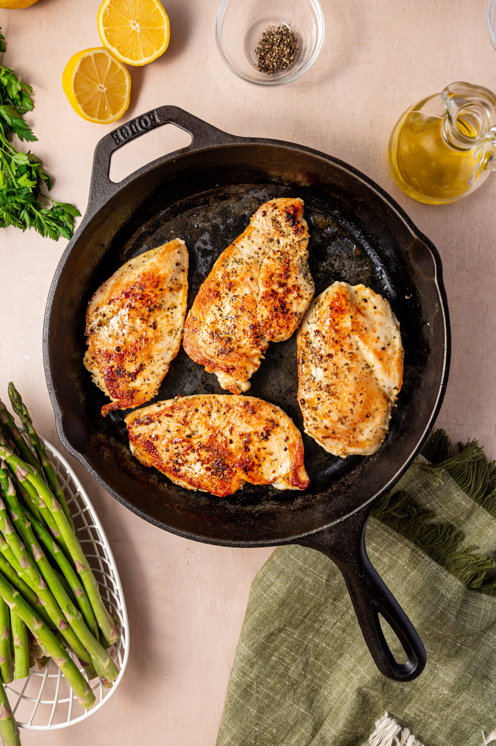 Chicken searing in a cast iron skillet.