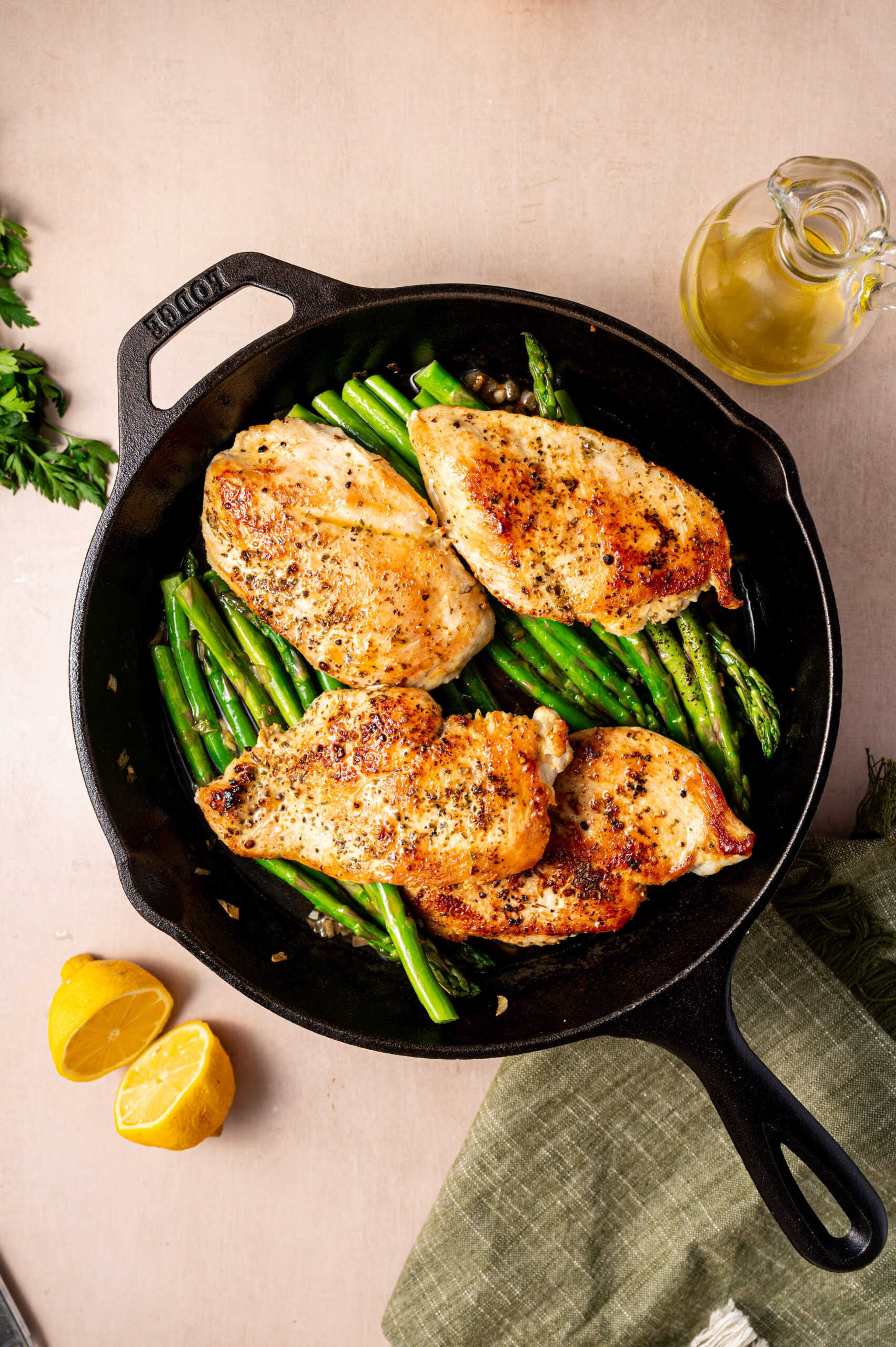 Seared chicken and sauteed asparagus on a skillet ready to eat.