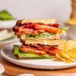 A tasty BLT sandwich on a plate with chips.