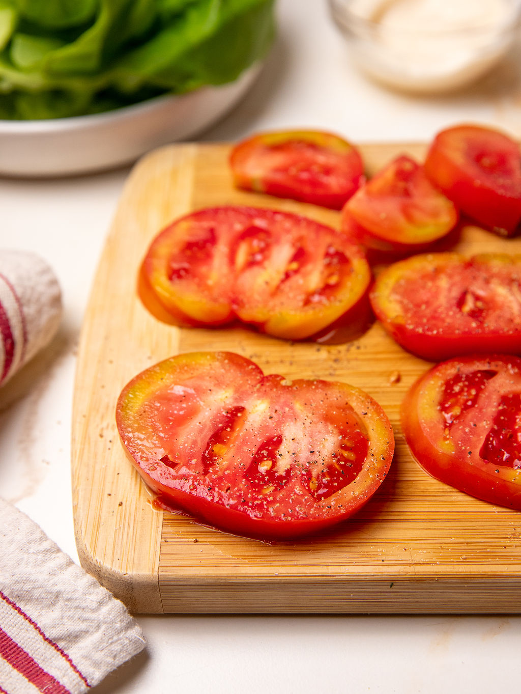 Sliced tomatoes on a cutting board.