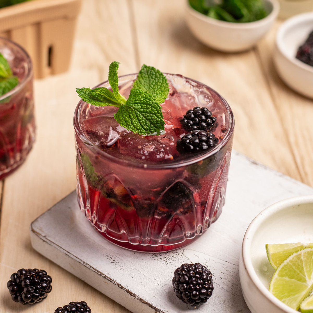 Blackberry mule garnished with fresh blackberries and mint on a serving plate.