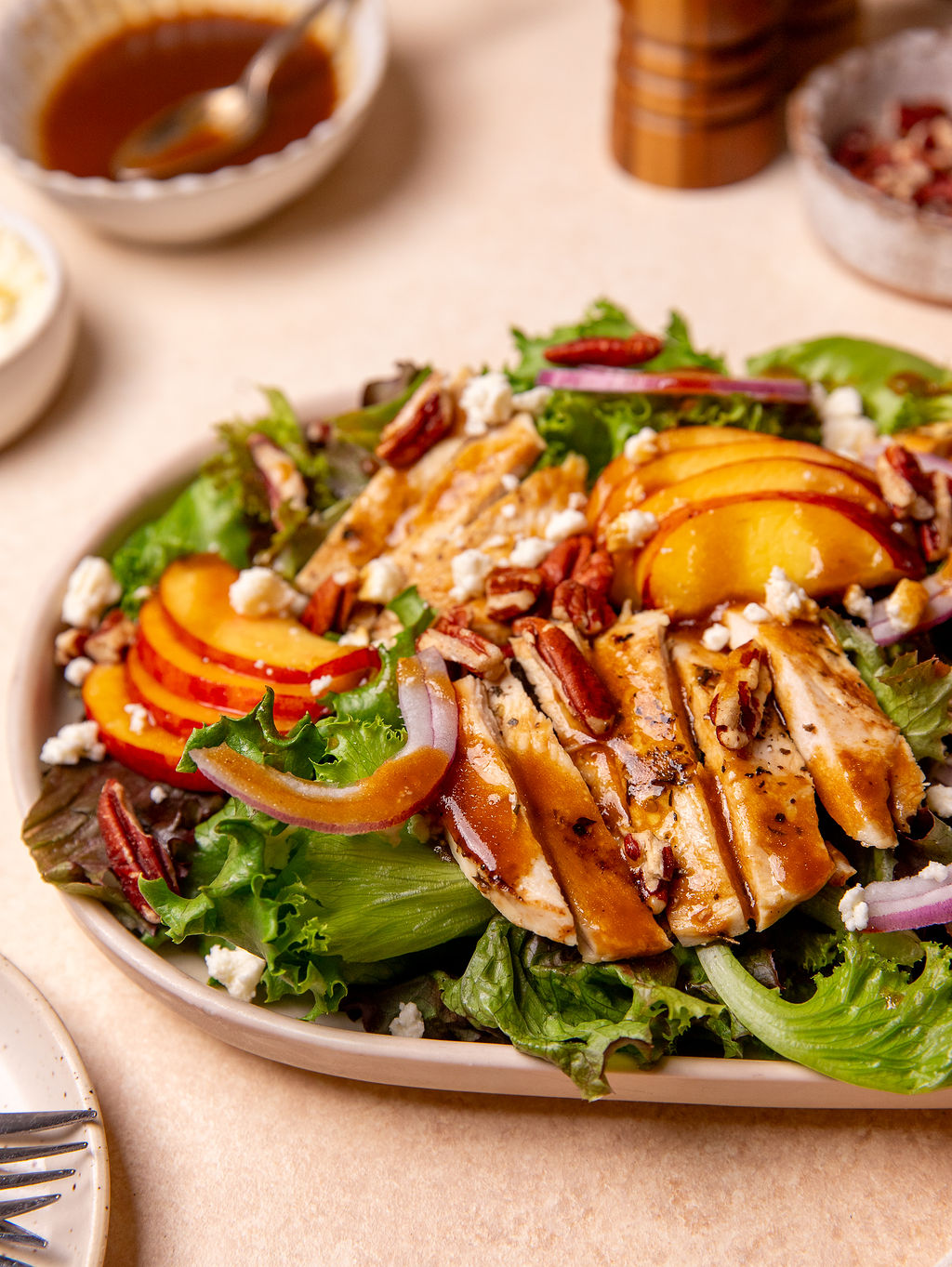 Grilled chicken and peach salad on a serving tray.