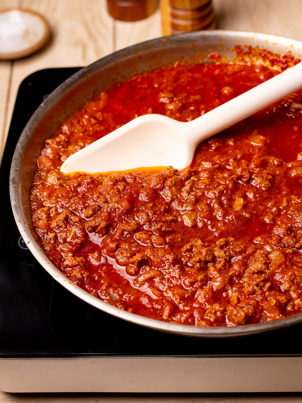 Meaty chili in a skillet over the stove.
