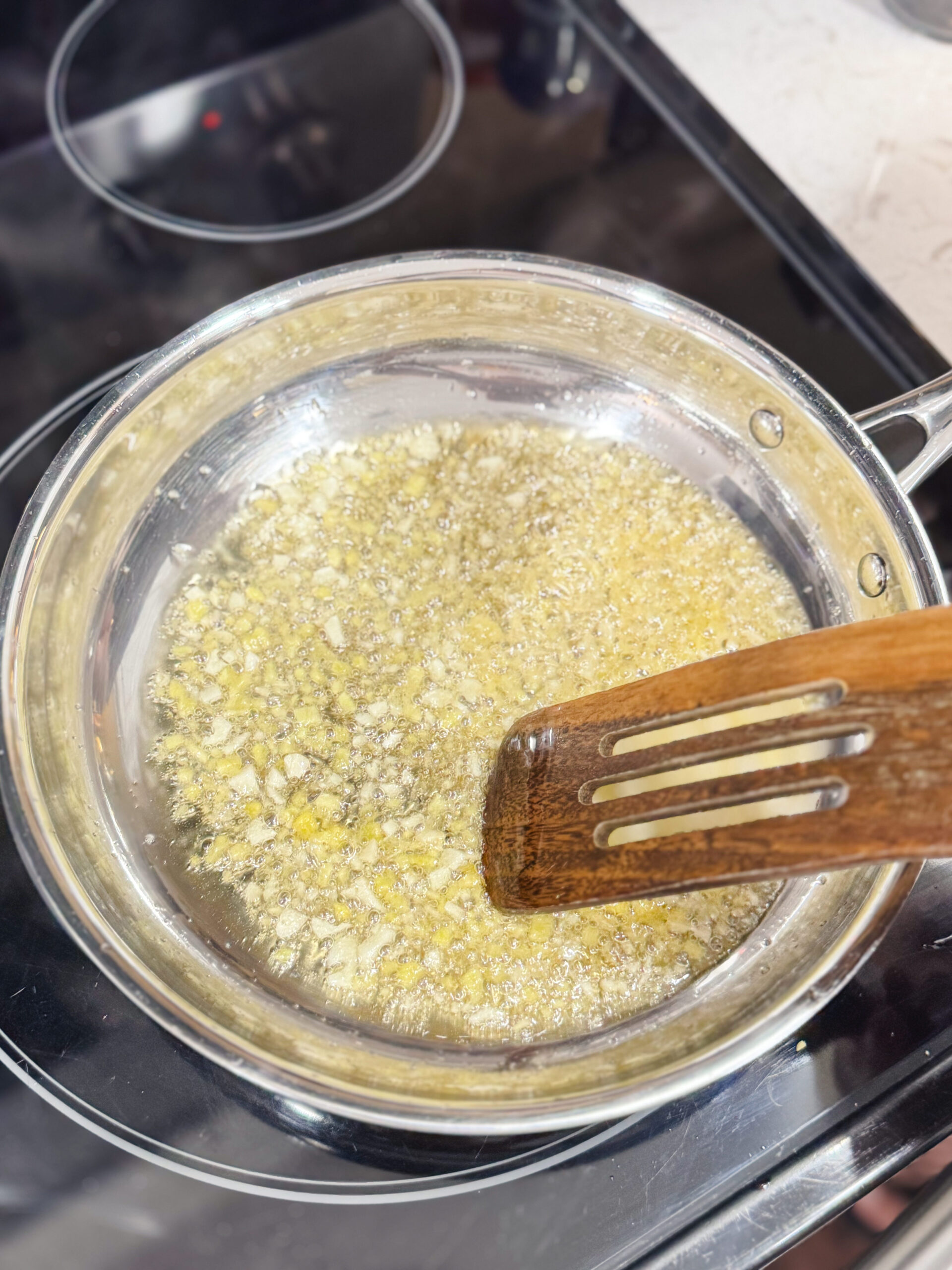 Sauteing garlic and ginger in a skillet.