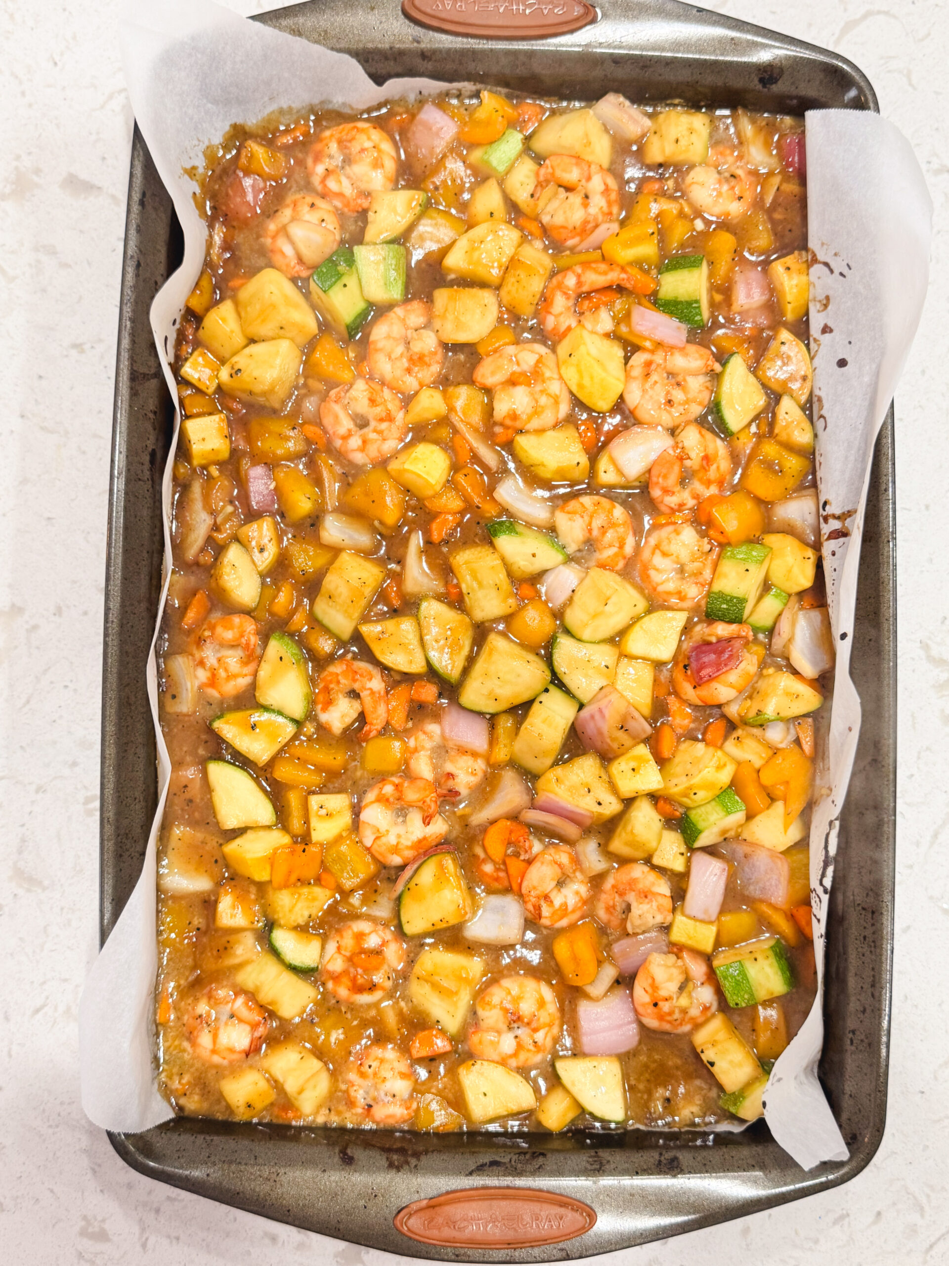 Sheet pan teriyaki shrimp fresh out of the onion.