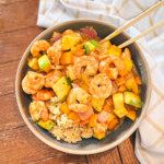 Sheet pan teriyaki shrimp in a bowl with chopsticks.