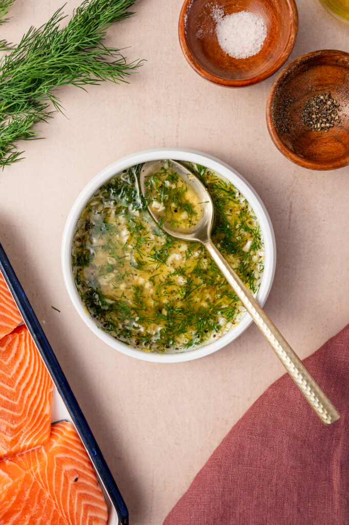 A small white bowl of lemon dill sauce.