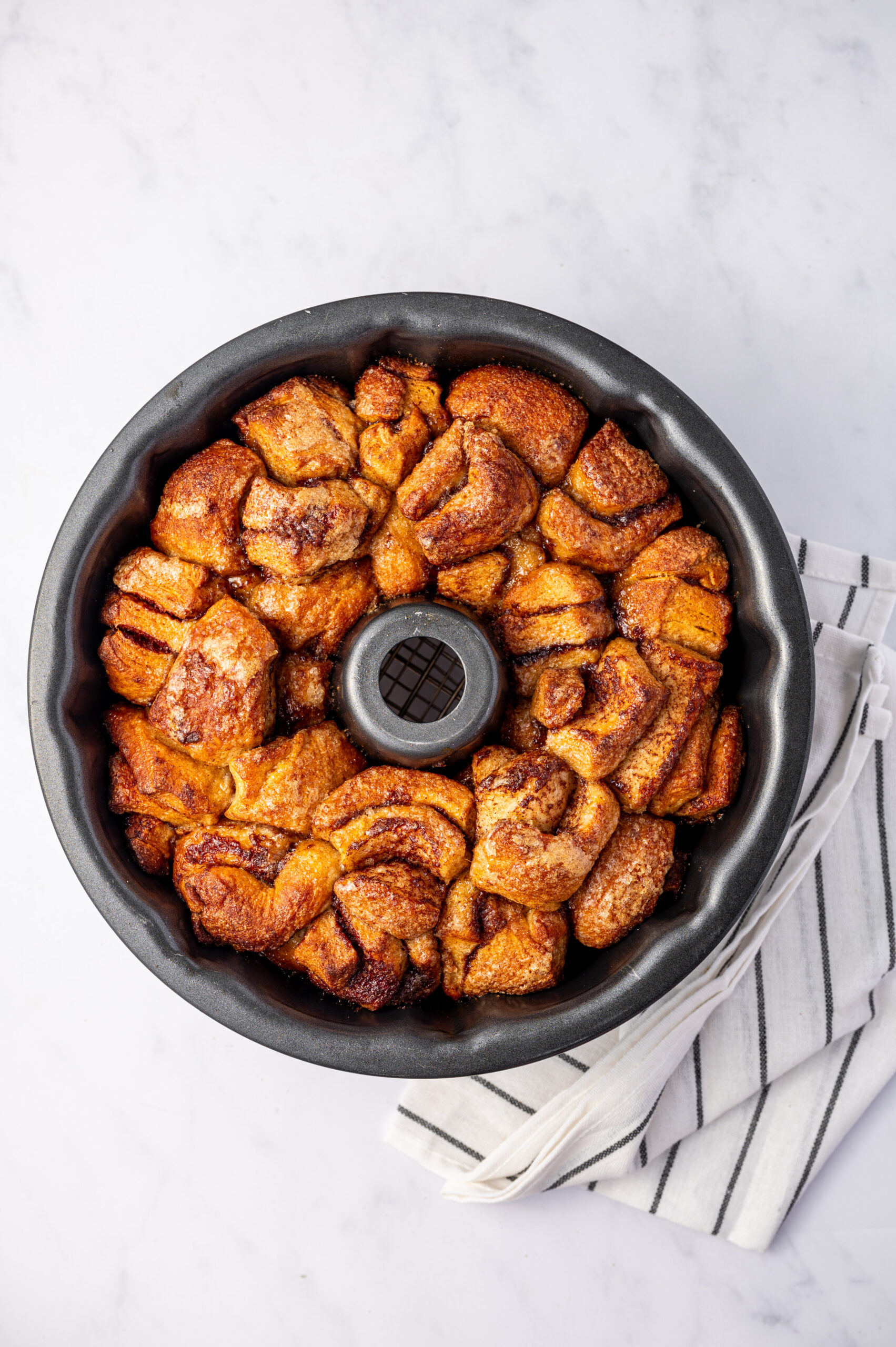 Cinnamon roll monkey bread fresh out of the oven in a bundt cake pan.