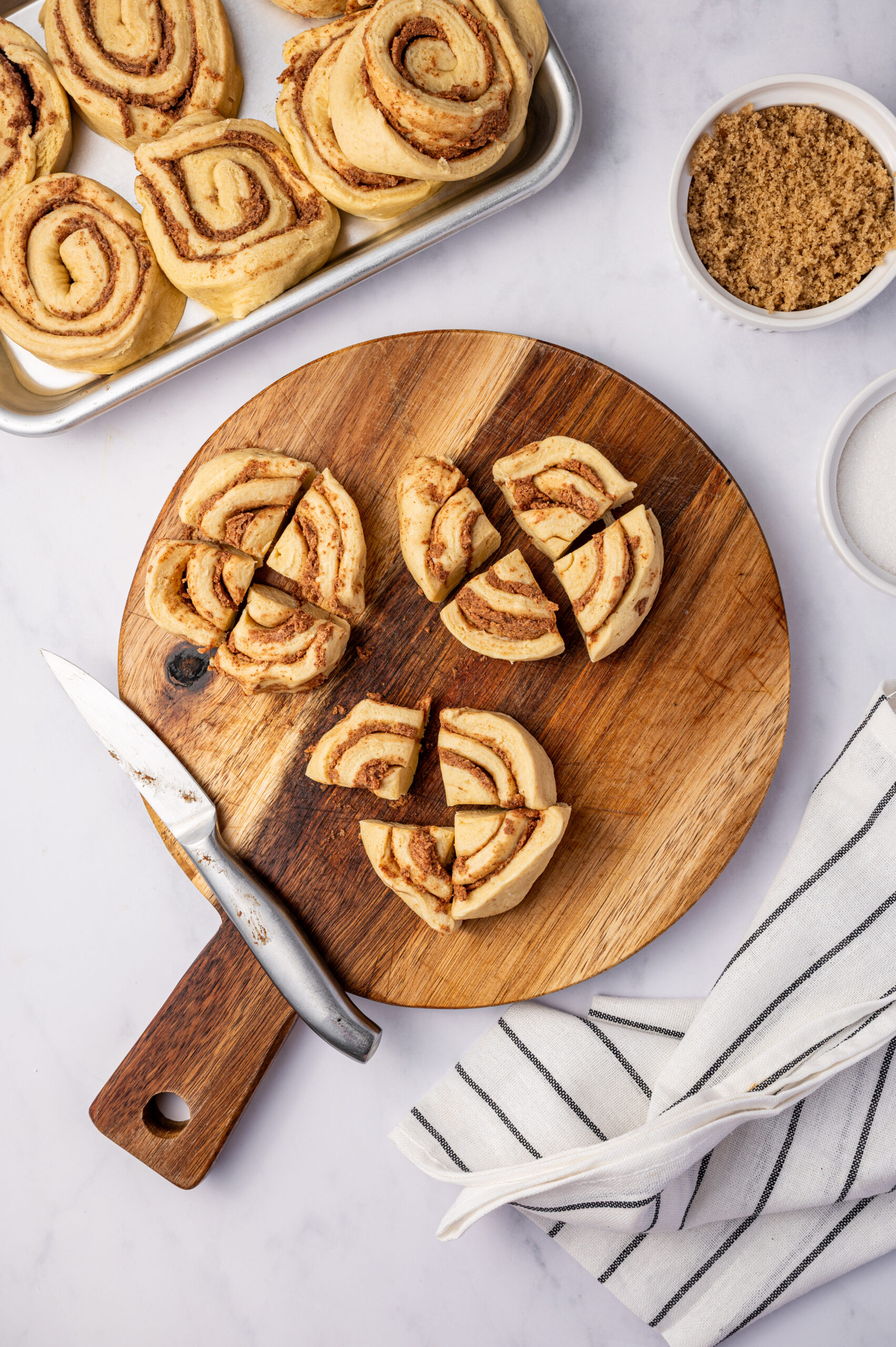 Cutting cinnamon rolls in four pieces.