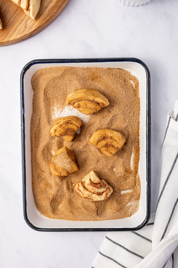 Cut up cinnamon rolls in a shallow dish of cinnamon sugar.