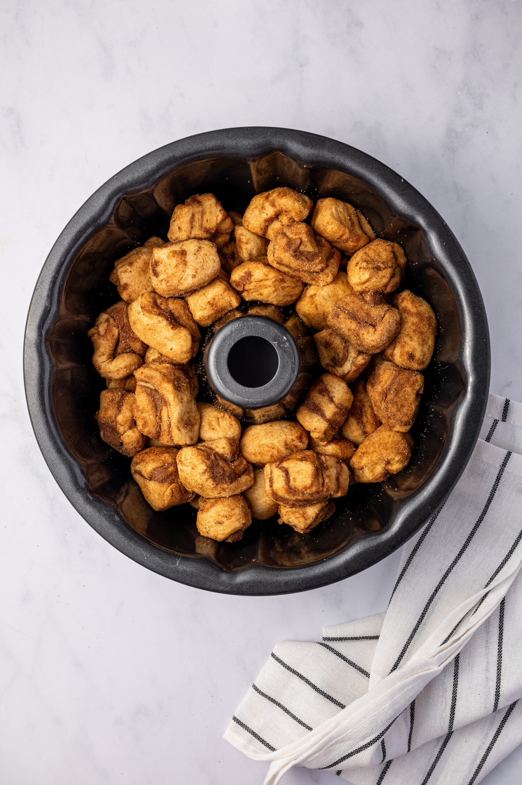 Cut up cinnamon rolls in a bundt cake pan.