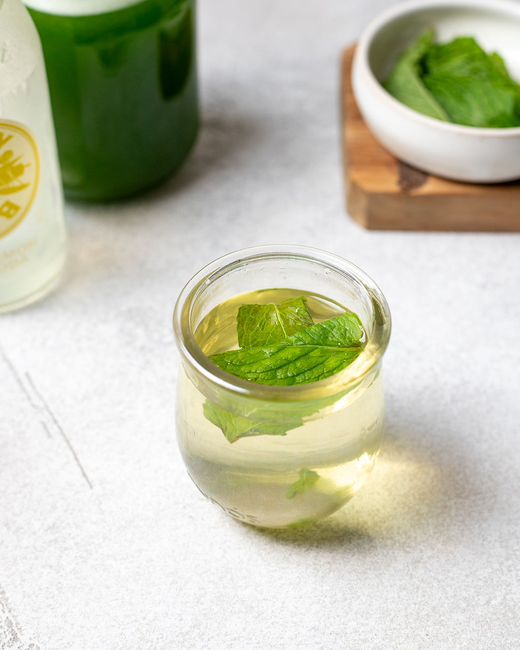 Steeping mint simple syrup in a glass.