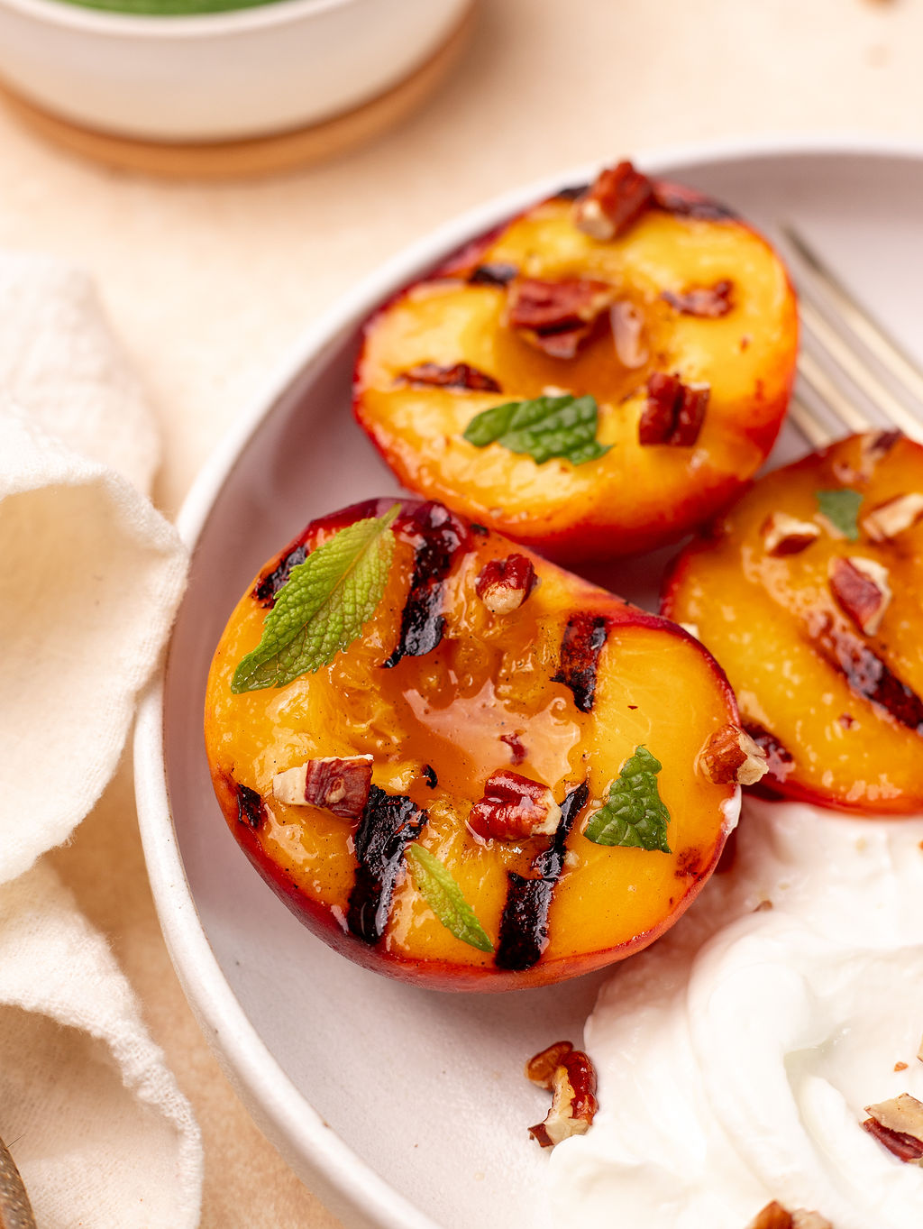 Close-up of grilled peaches with a side of Greek yogurt.
