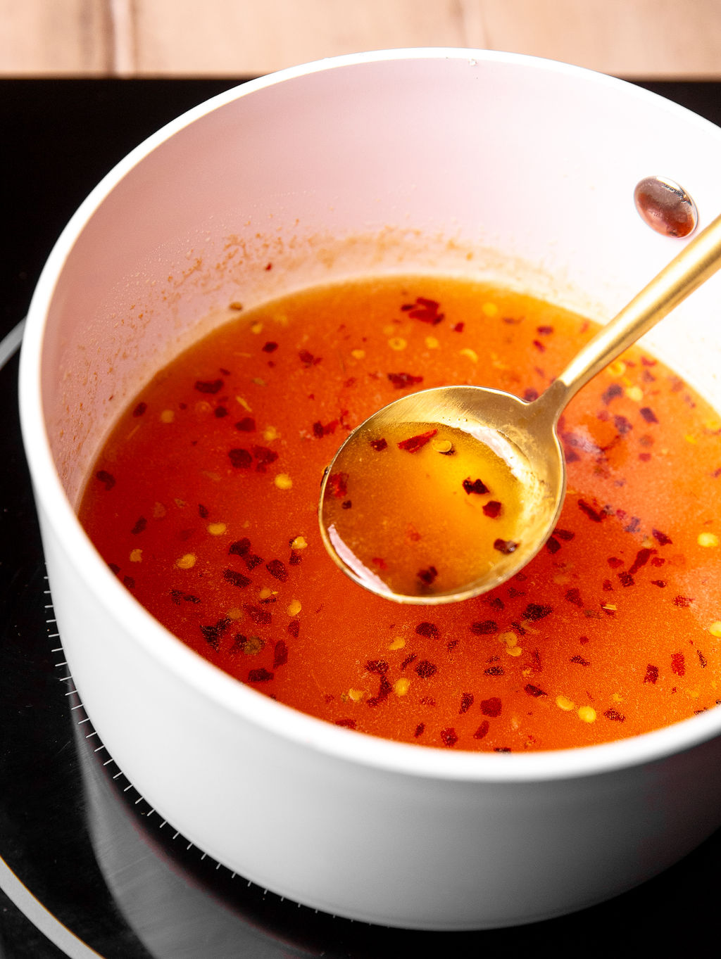 Hot honey sauce in a white bowl.