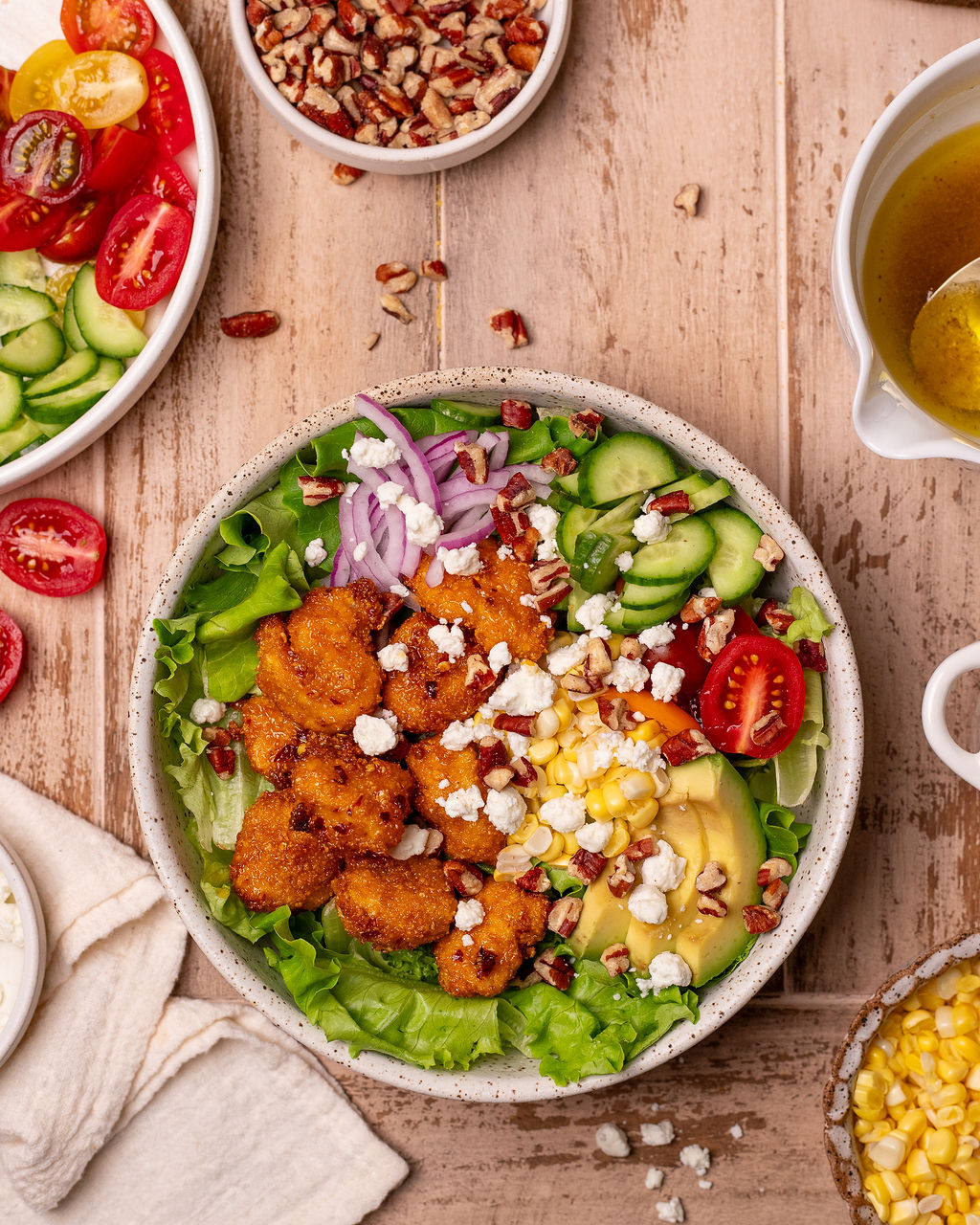 A serving of hot honey chicken salad surrounded by ingredients.