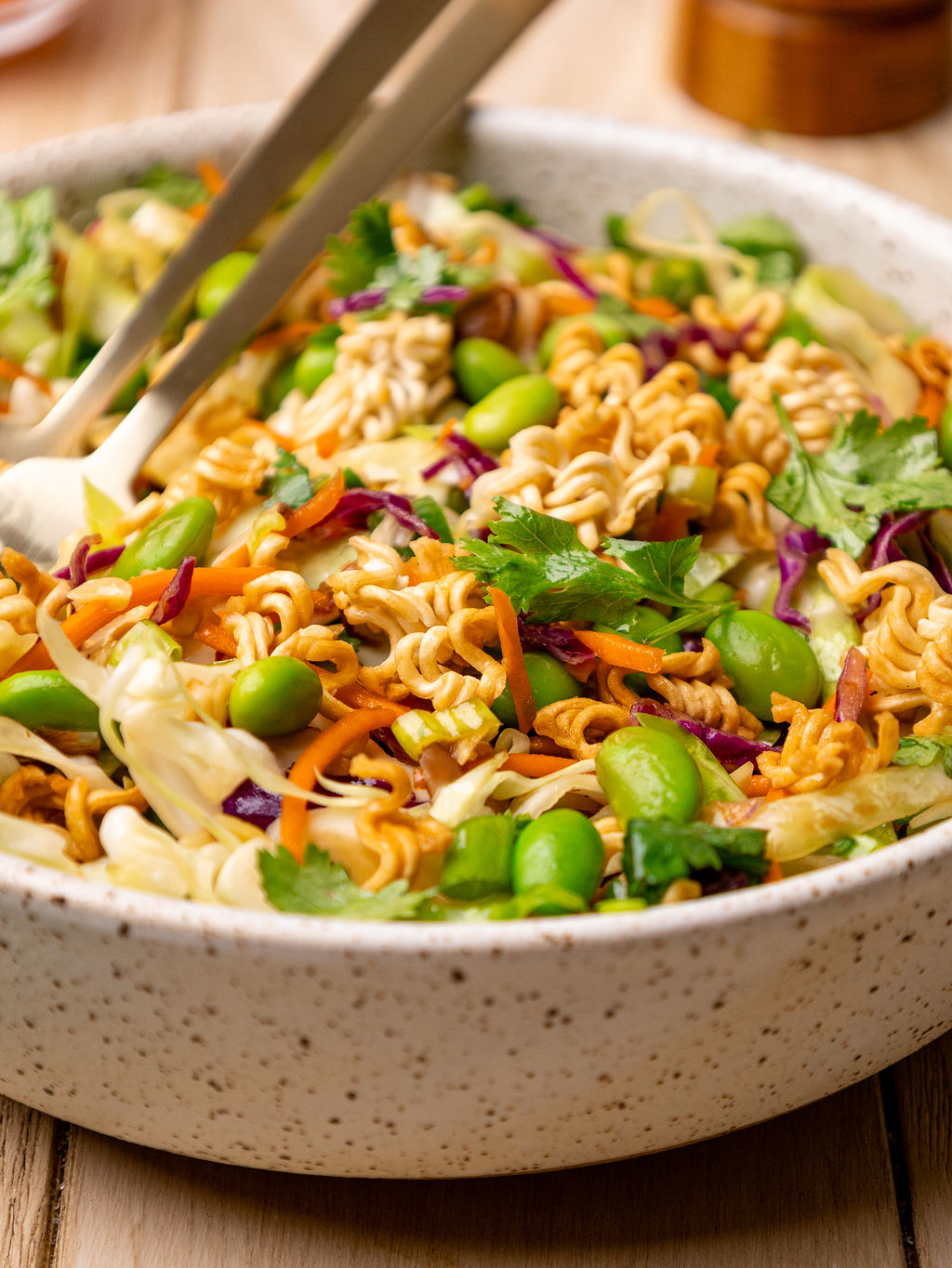 Close-up of ramen noodle salad in a white bowl.