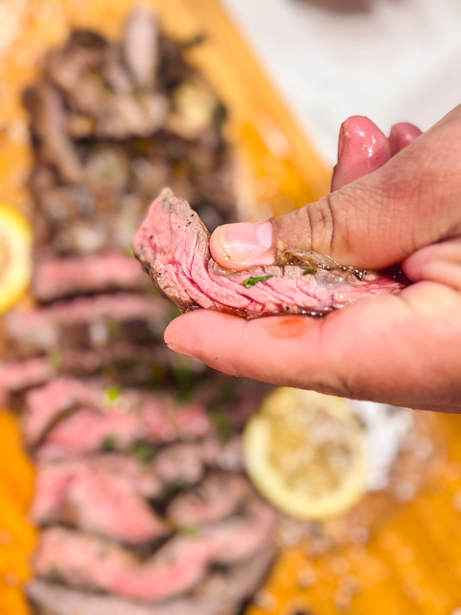 Close-up shot of a slice of perfectly medium rare skirt steak.