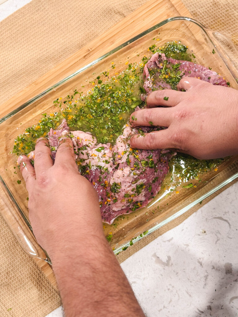 Marinating skirt steak in a glass dish.